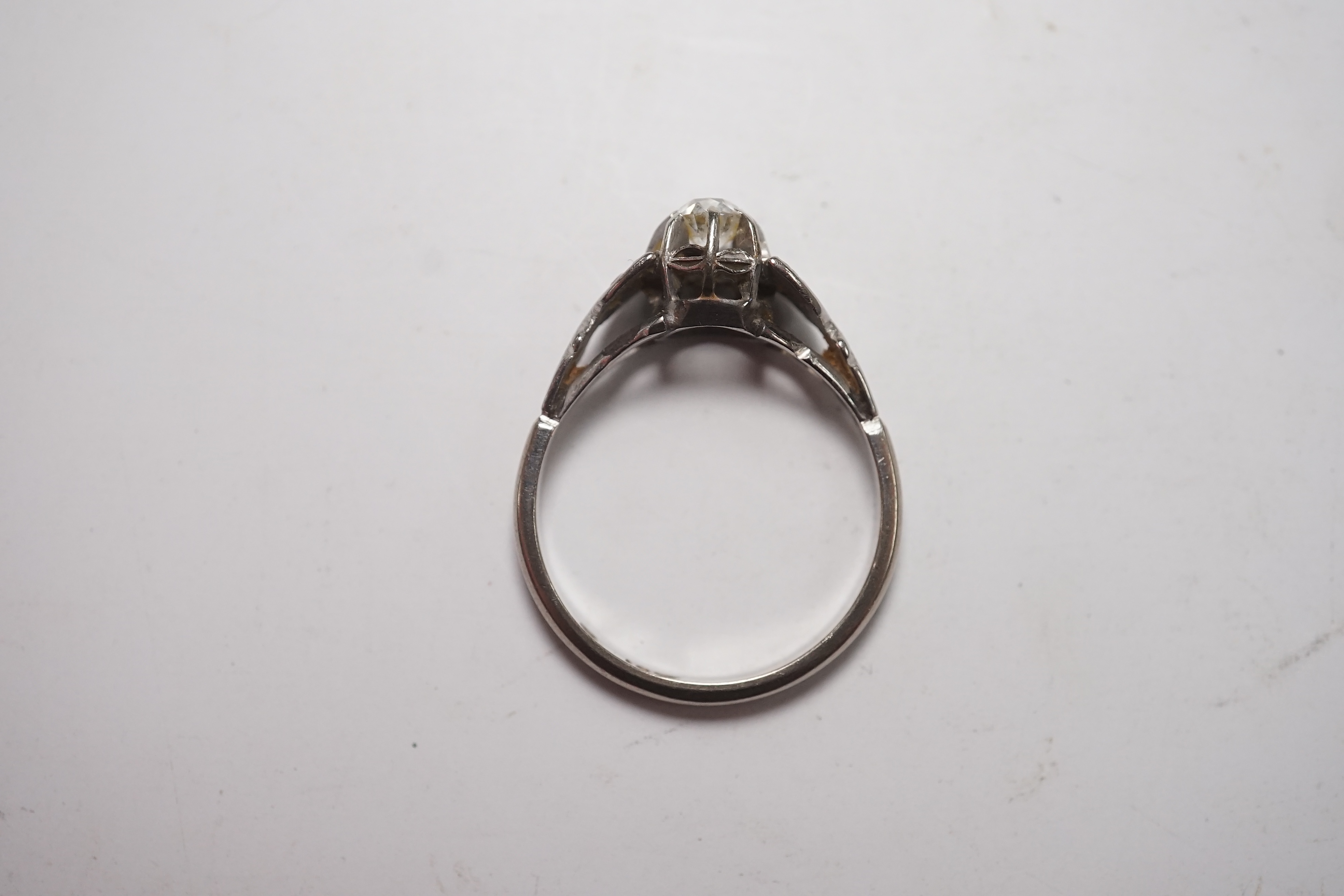 An 18ct white metal and cushion cut solitaire diamond ring, size N/O, gross weight 2.6 grams. Condition - fair